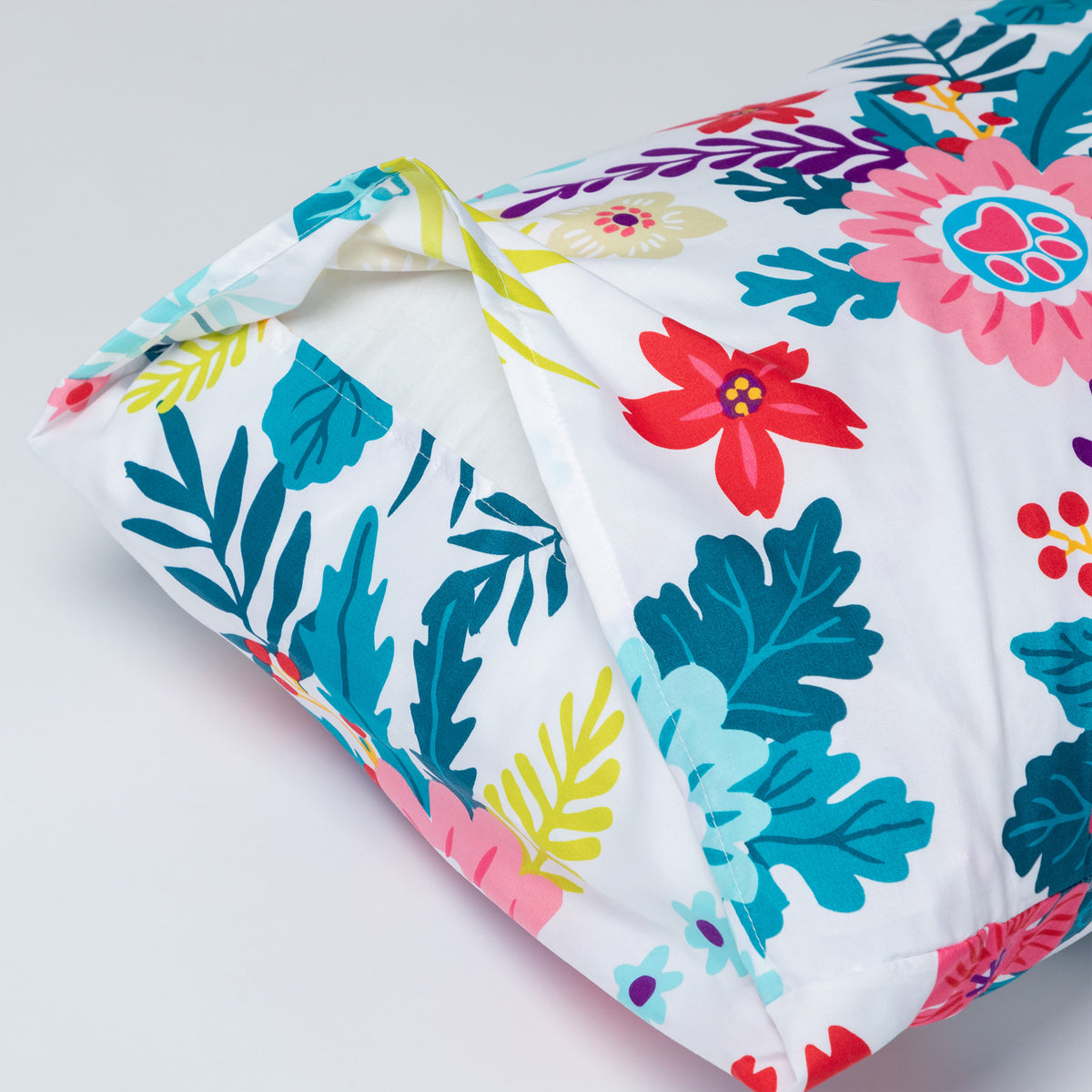 Garden of Paws microfiber sheet set with bright color floral an fauna design detail of pillowcase fold on edge