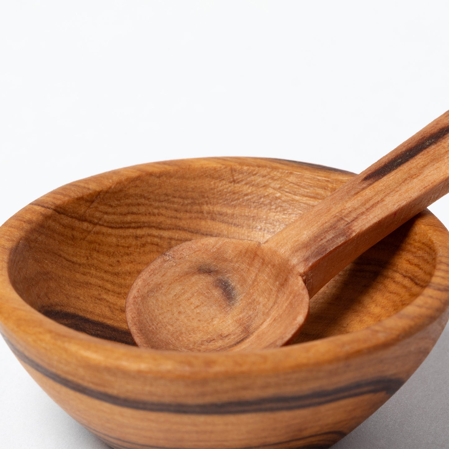 Wooden bowl and spoon on a white background