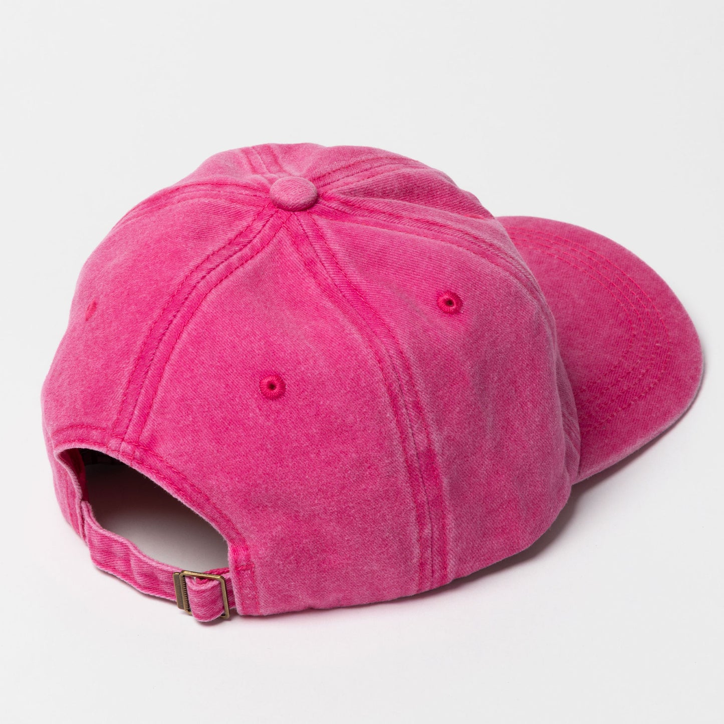 Pink baseball cap on a light gray background