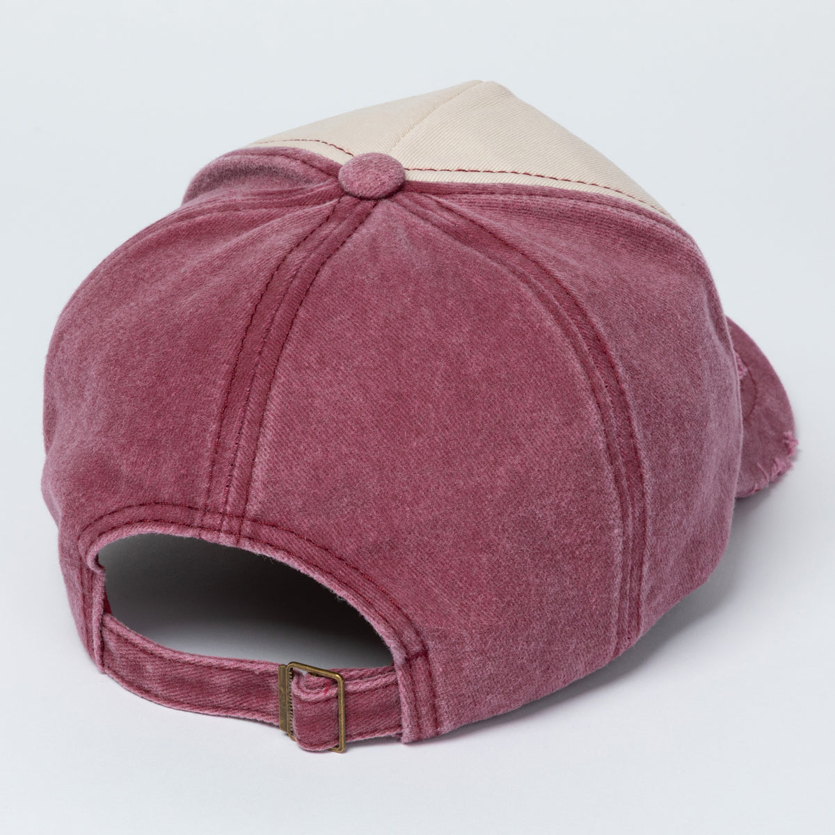 Red and beige baseball cap on a light gray background