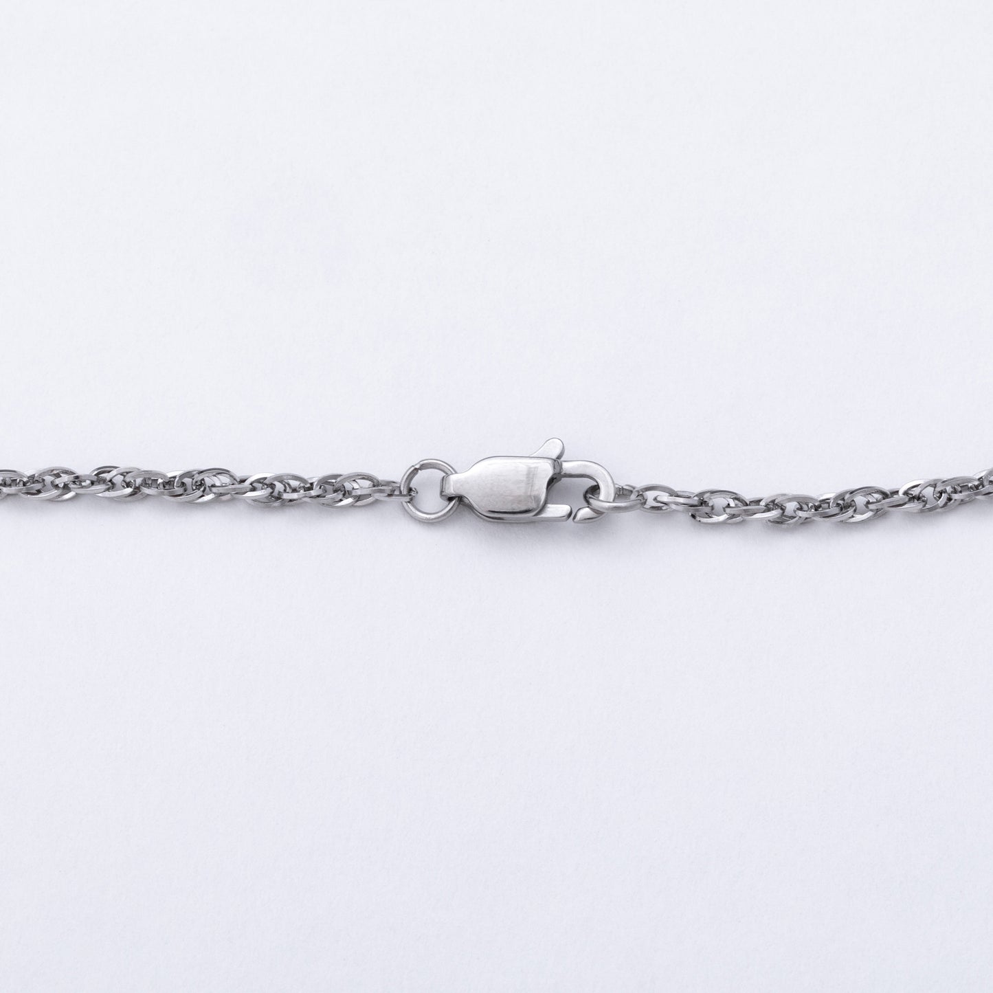 A close-up of a silver-toned metal chain necklace with a lobster clasp, shown against a plain white background.