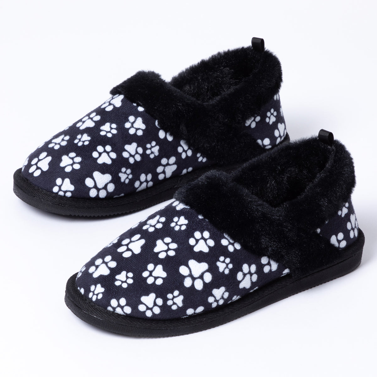 Black faux fur lined paw printed slipper shoes on a white background.