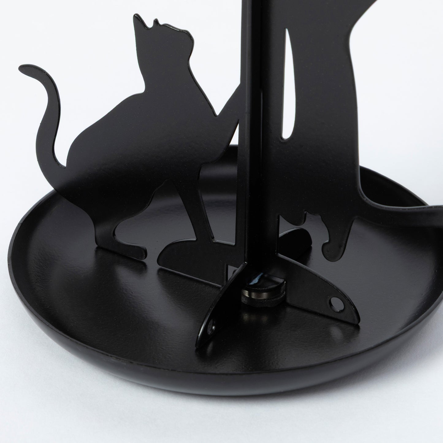 Black metal cat-shaped jewelry organizer with a round tray base and vertical stand, photographed on a clean white background.