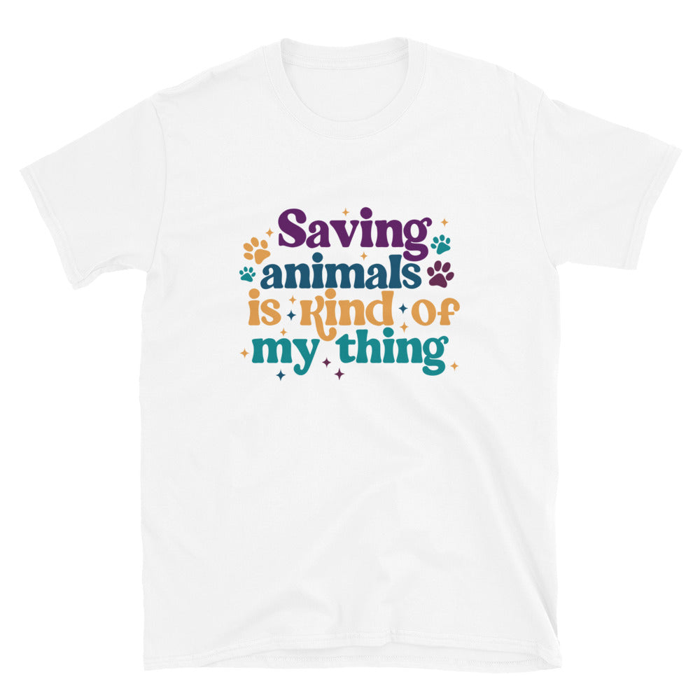 White shirt that reads Saving Animals is kind of my Thing with several paw print and sparkle images in a purple, yellow and blue font.