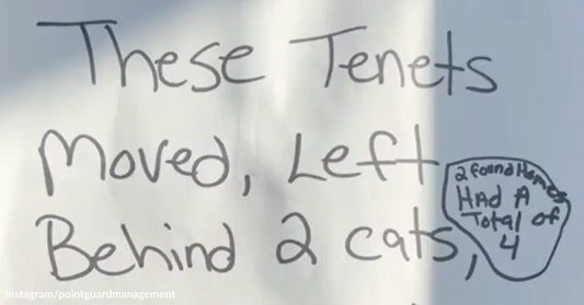 A handwritten sign reads “These tenants moved, left behind 2 cats,” with a small note adding that four animals were found.
