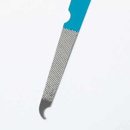 A close-up of a nail file or cuticle tool with a bright turquoise handle and a textured silver metal abrasive section, shown on a plain white background.
