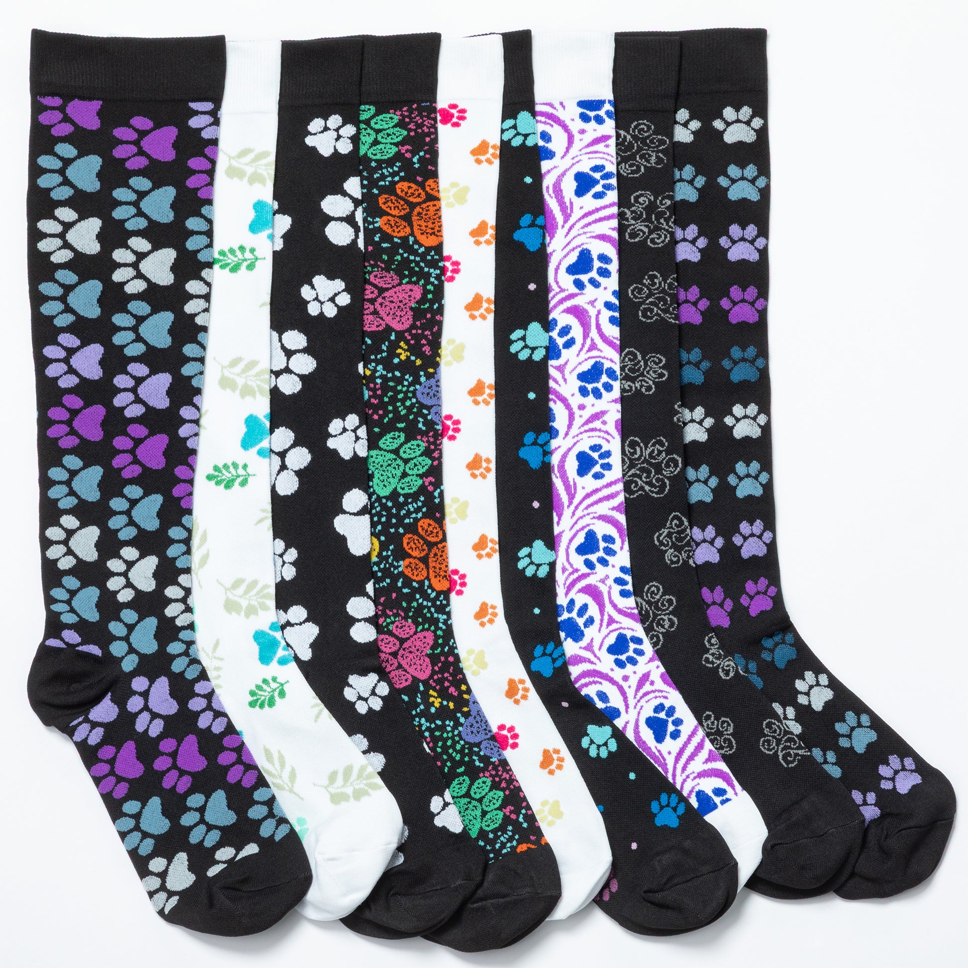 A collection of compression socks with varying paw print designs, displayed in colors black, white, blue, green, and purple.