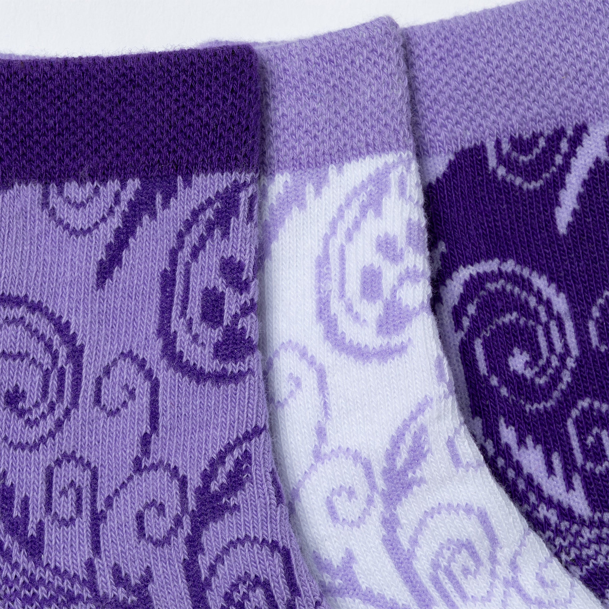 Each design included in the flourish paws purple set of three ankle-length socks. Close-up of the durable, breathable fabric on the cuff and main part of the socks. 