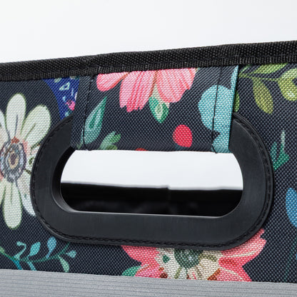 Close up of floral-patterned handle on a floral fabric background