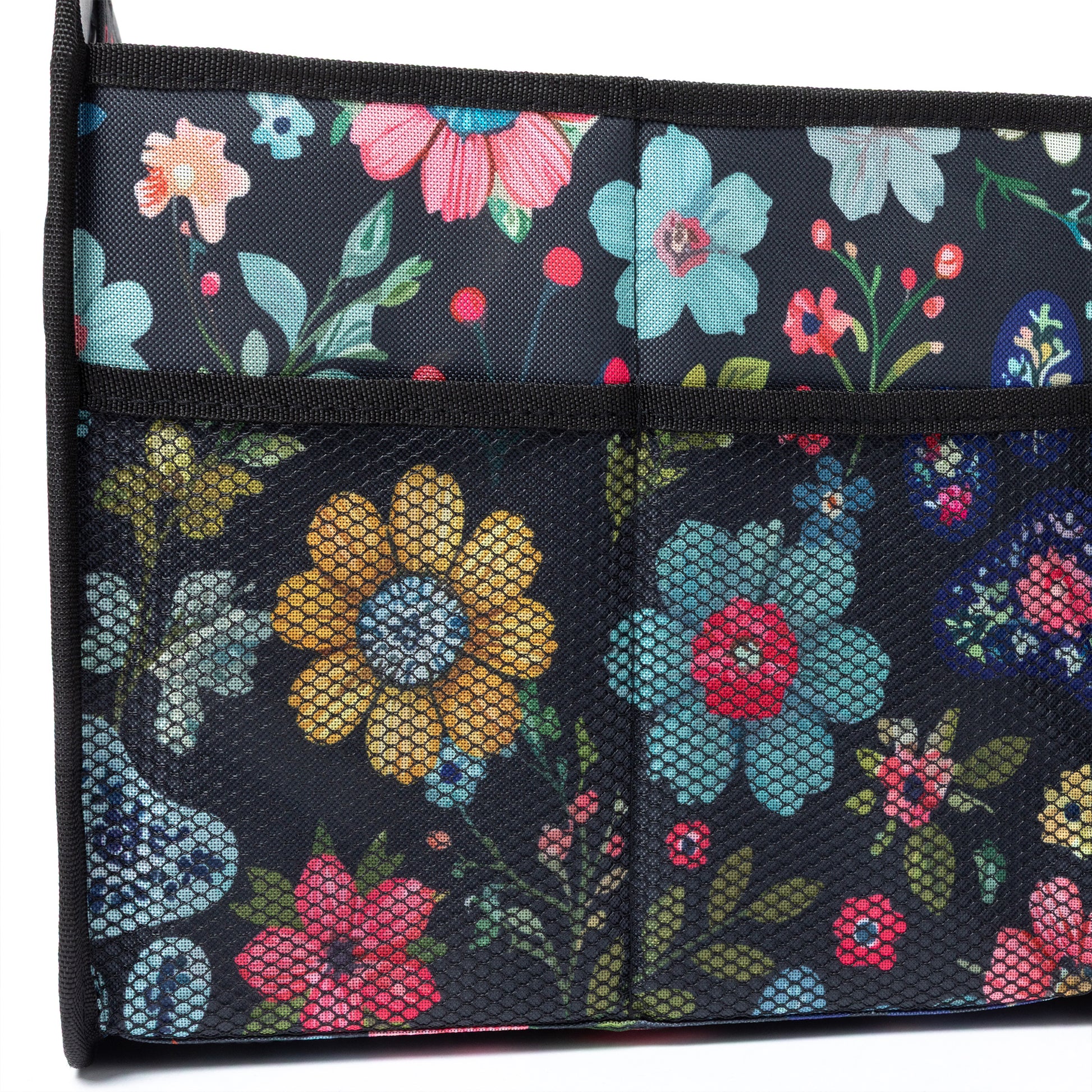 Floral-patterned trunk organizer with colorful flowers on a dark background.