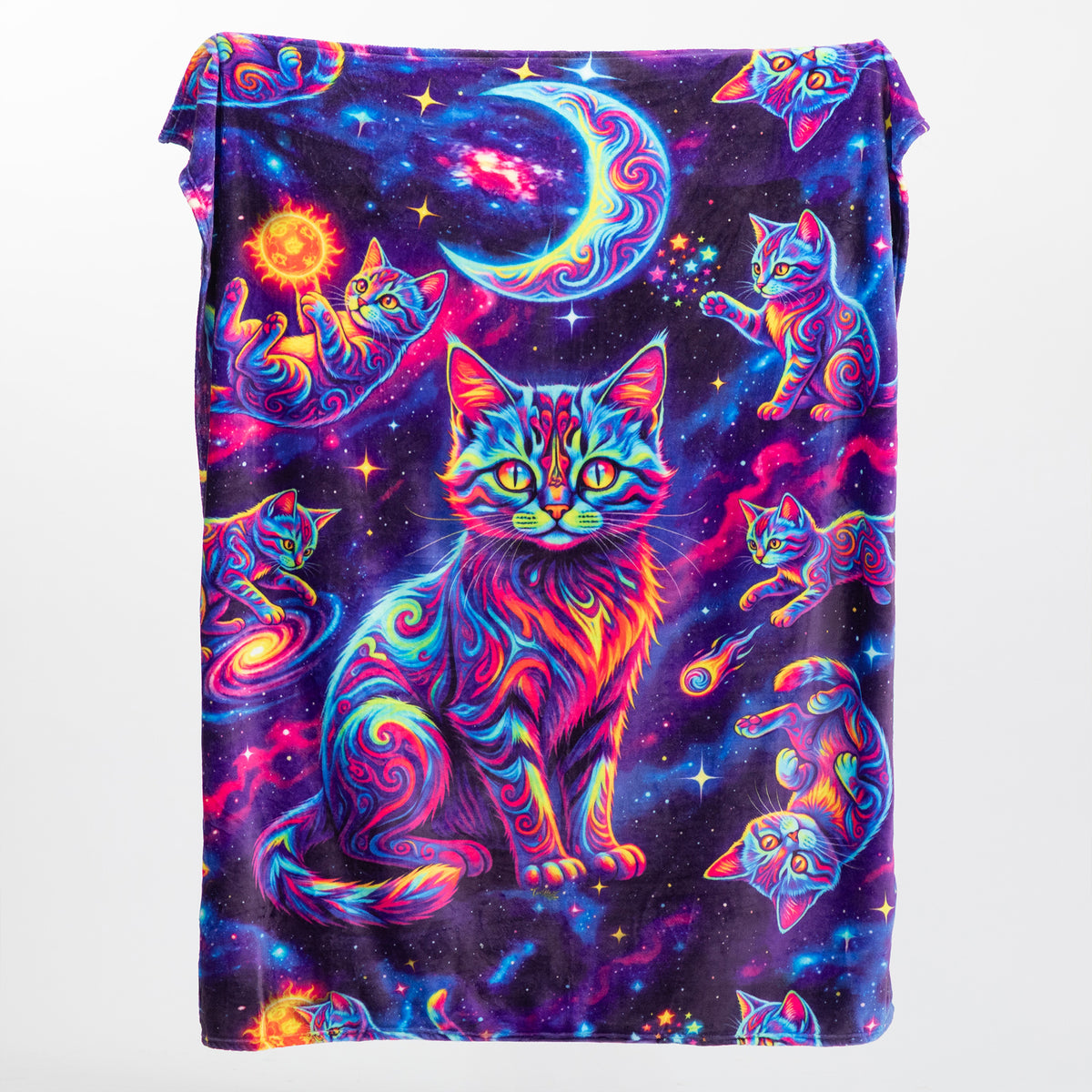 A folded blanket featuring a vibrant, psychedelic cosmic print with multiple cats in neon colors against a starry space background.