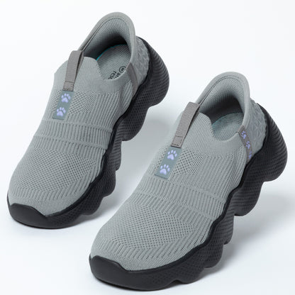 Pair of gray slip-on shoes with paw print accents on a white background