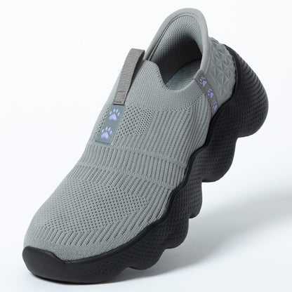 Gray slip-on shoe with black sole on a white background