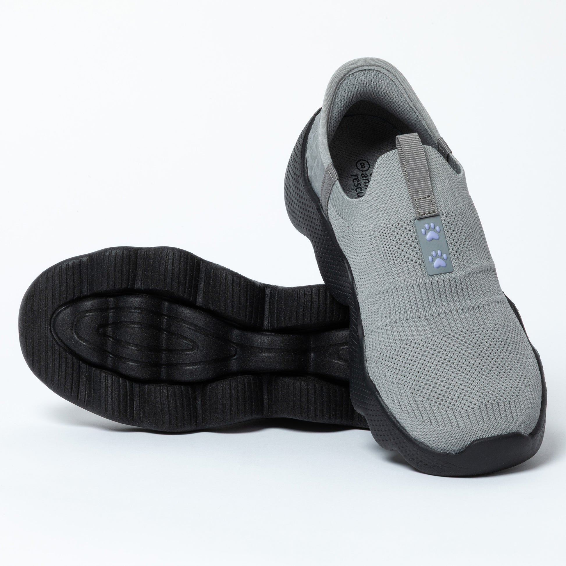 Gray slip-on shoe with black sole on a white background