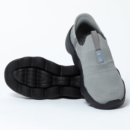 Gray slip-on shoe with black sole on a white background