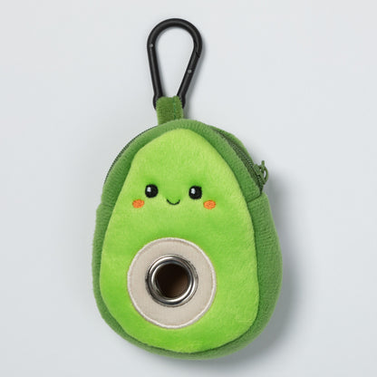 Green plush avocado-shaped keychain with a carabiner for pet waste bags on a light gray background.