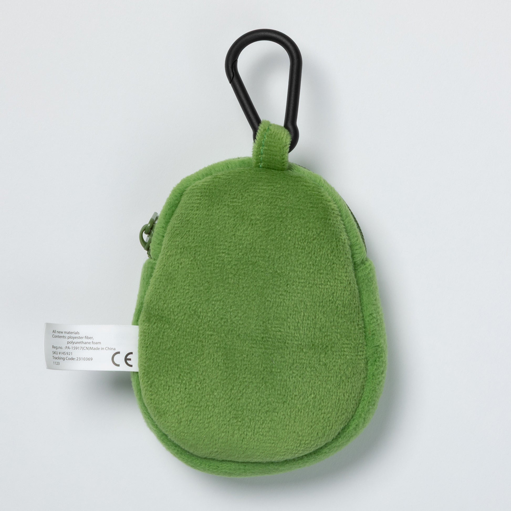 Green plush avocado-shaped keychain with a carabiner for pet waste bags on a light gray background.