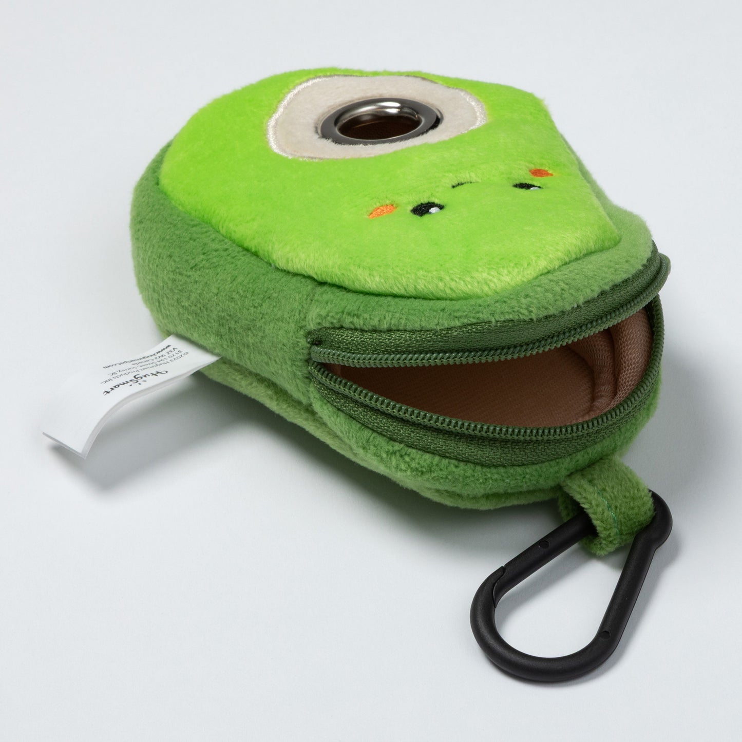 Green plush avocado-shaped keychain that holds/dispenses pet waste bags, with a zipper top for holding the roll of dog bags.