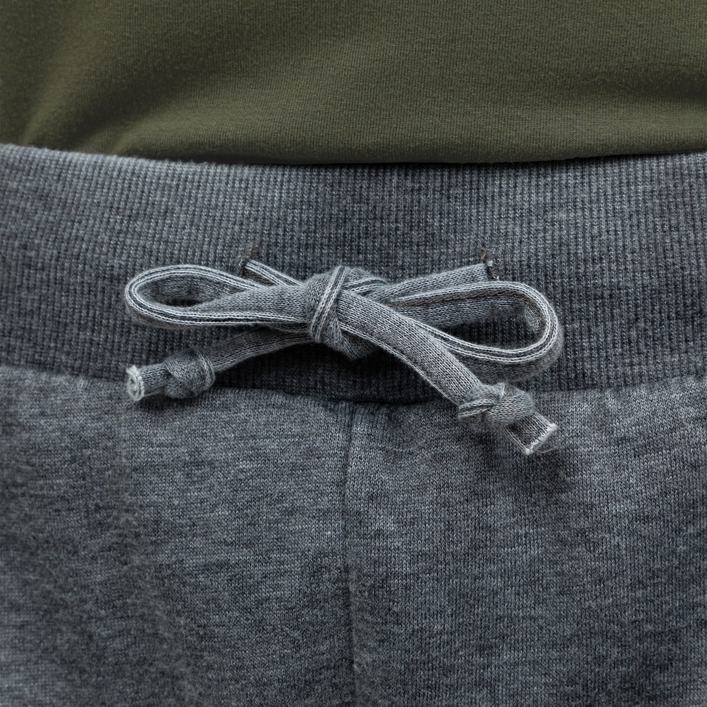 Close-up of gray drawstring waist on a gray pair of board shorts