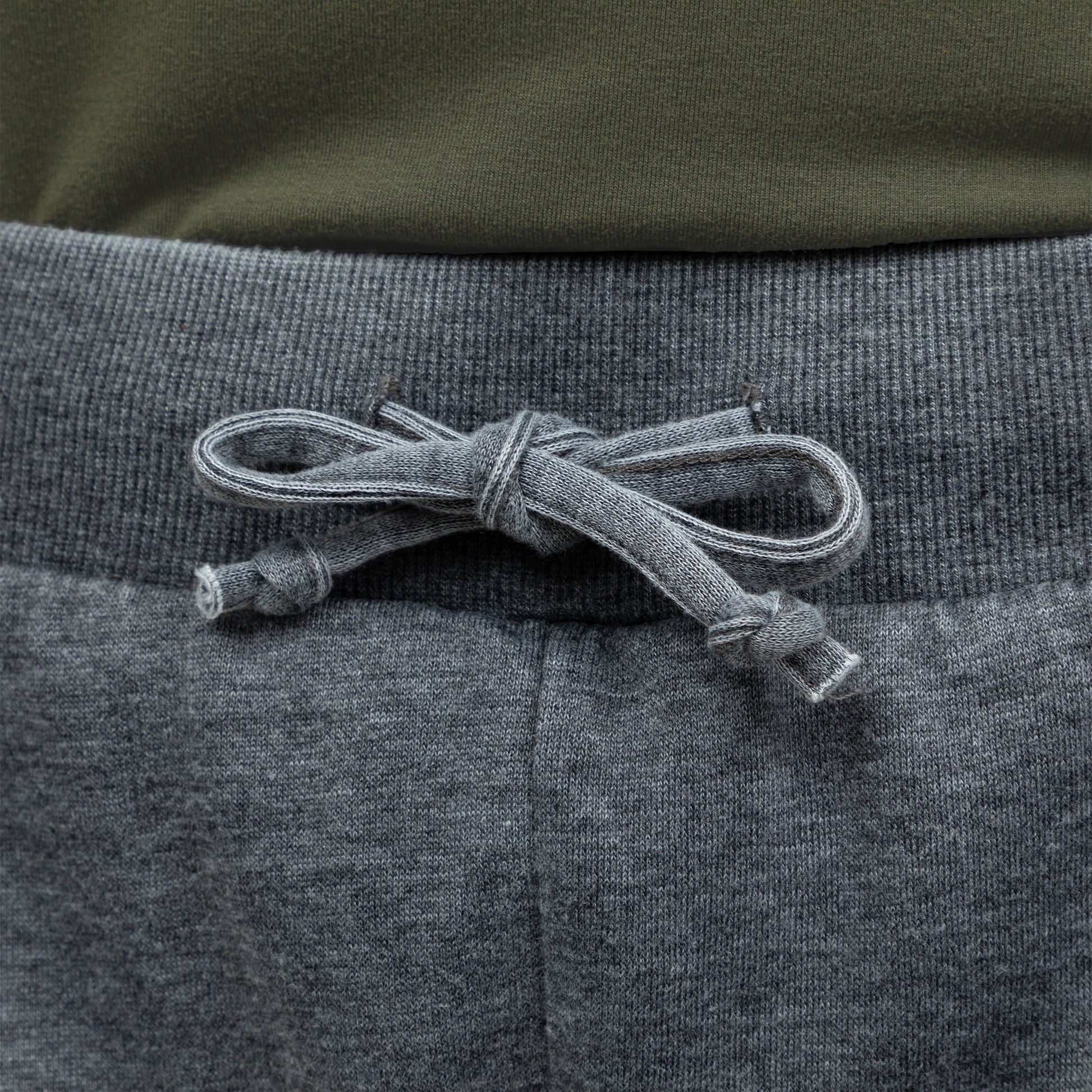 Close-up of gray drawstring waist on a gray pair of board shorts