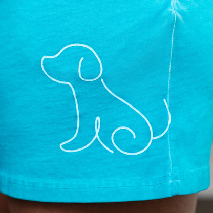 Turquoise shorts with a white outline of a dog on a plain background.