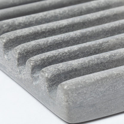Close up of the ridges on a gray soapstone soap dish.