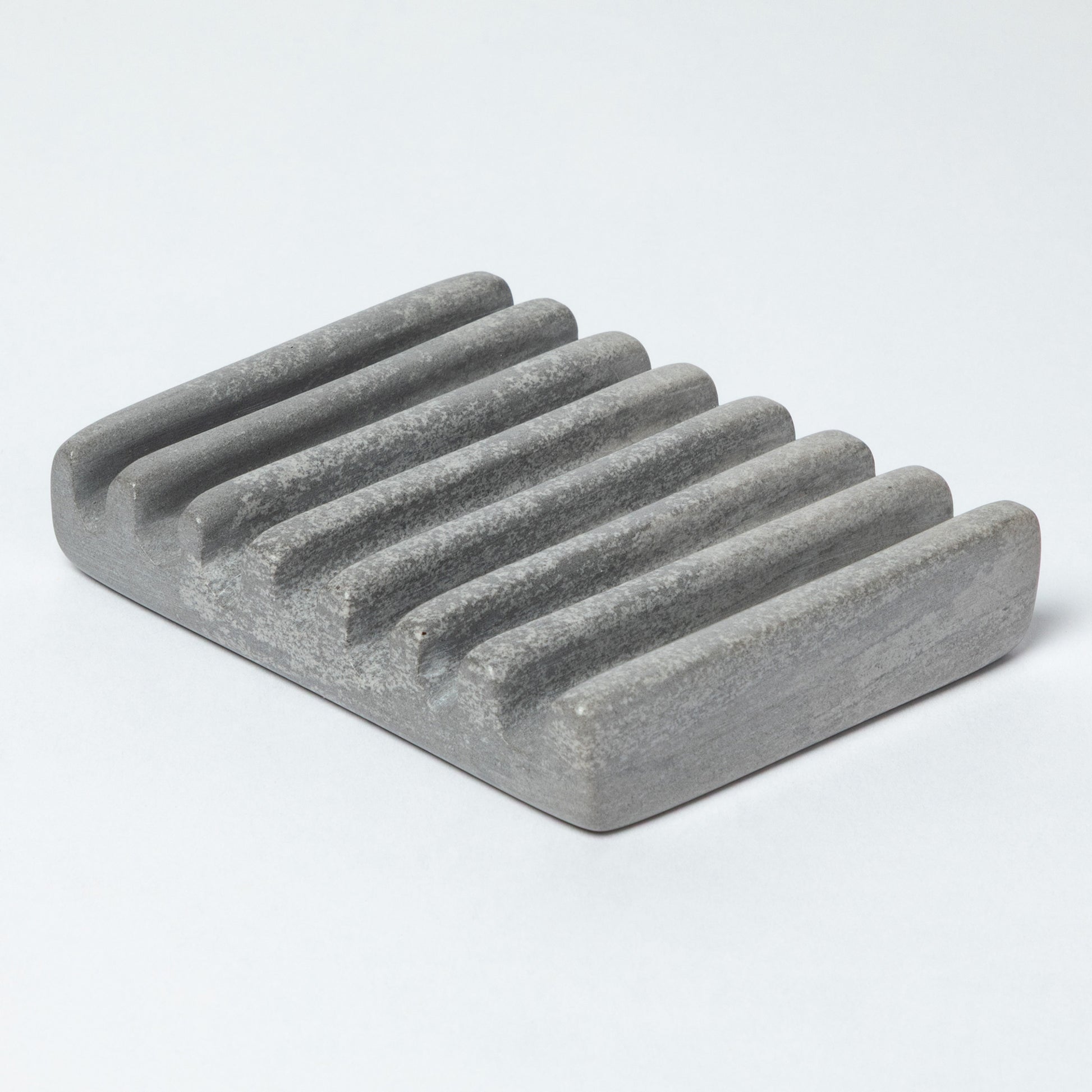 Gray stone soap dish on a light gray background