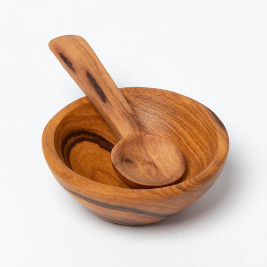 Wooden bowl and spoon set on a white background