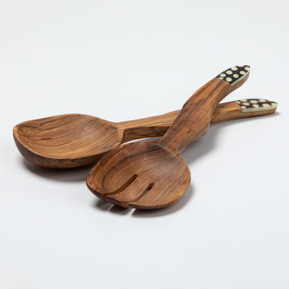 Wooden spoon and fork salad server set with decorative handles on a white background