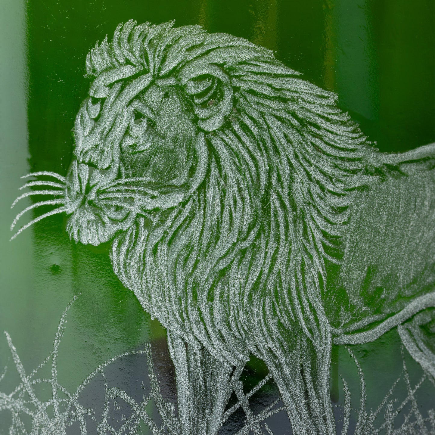 Detailed line drawing of a lion on a textured green recycled glass background