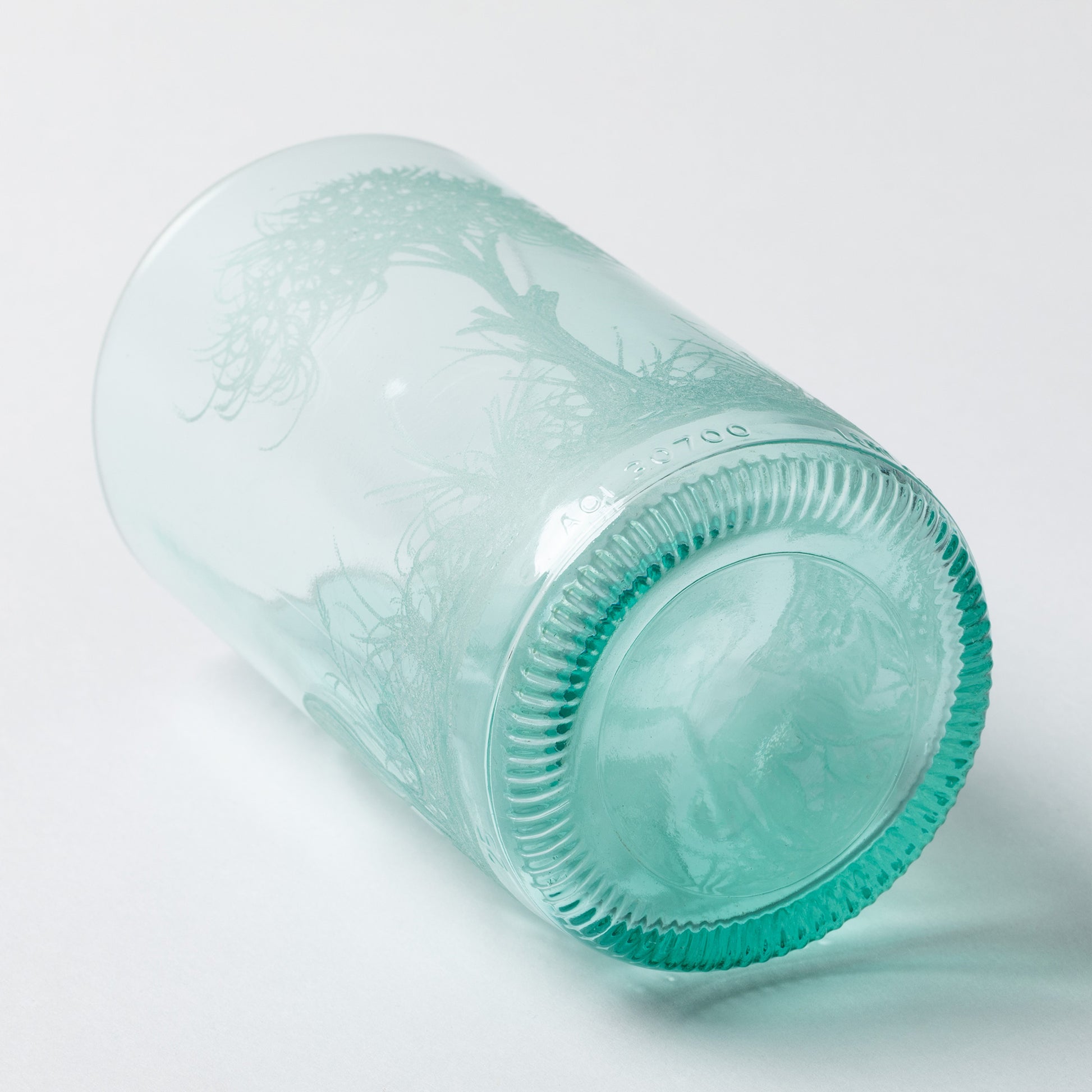 Clear recycled glass with the bottom showing, against a white background.