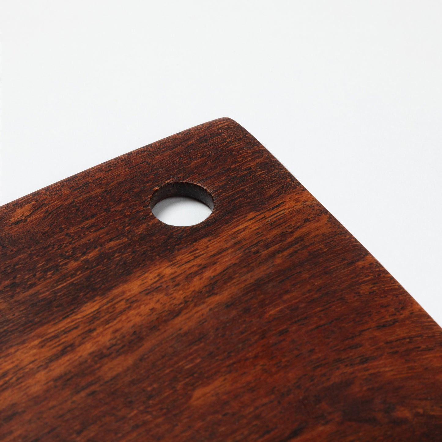 Close up of wooden pastry blade handle on a white background