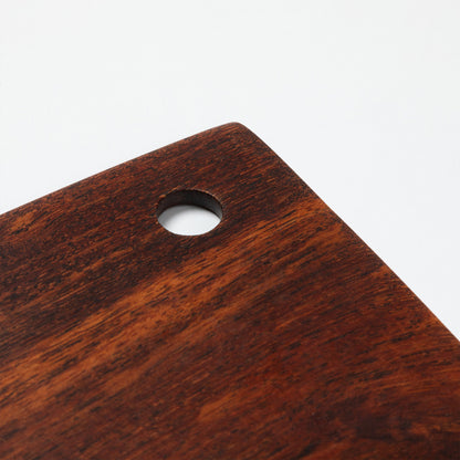 Close up of wooden pastry blade handle on a white background