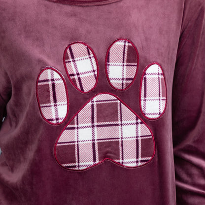Soft texture of the velour shirt. The plaid paw print is also made of the same fabric. There is red piping outlining the paw print. 