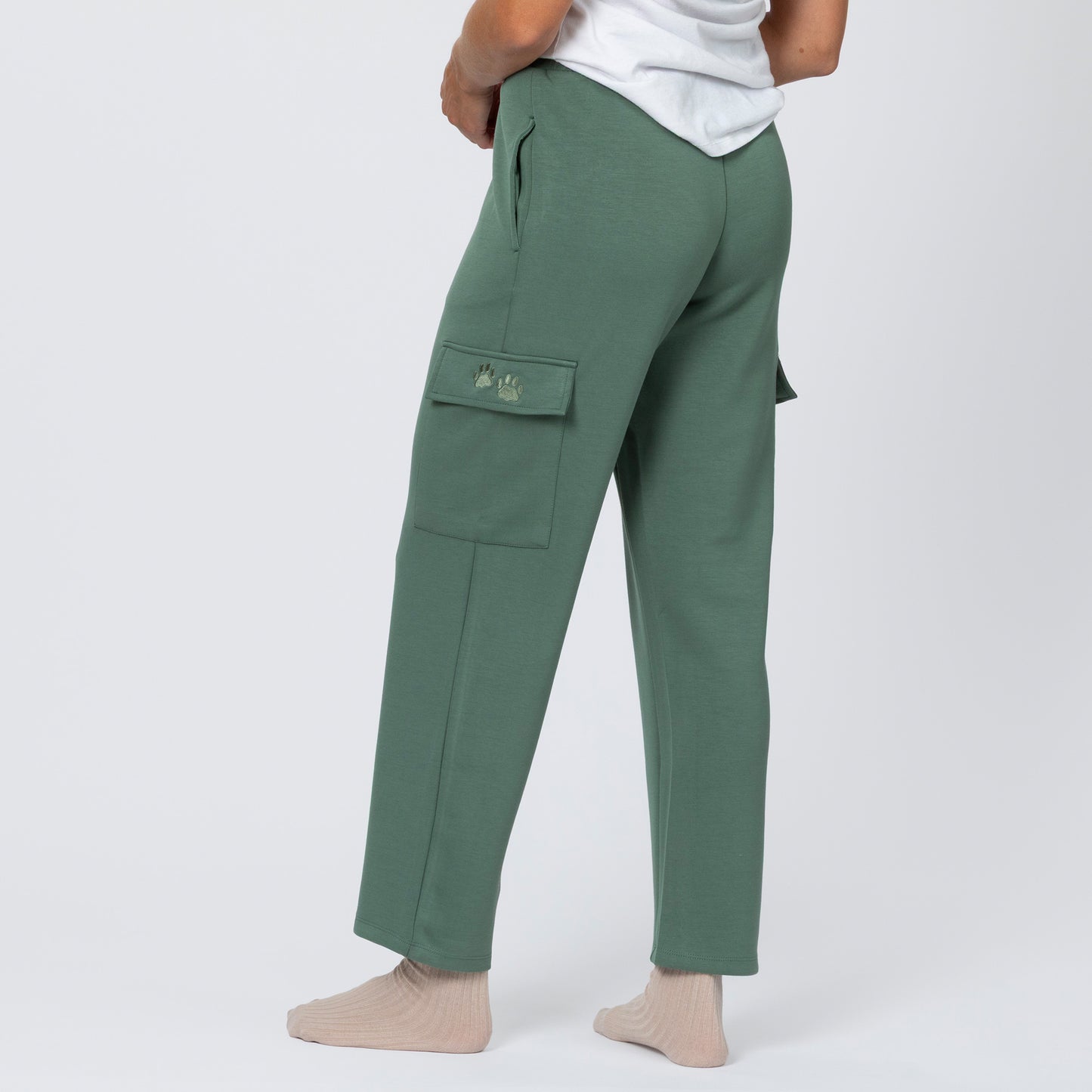 Green cargo pants worn by a person on a white background