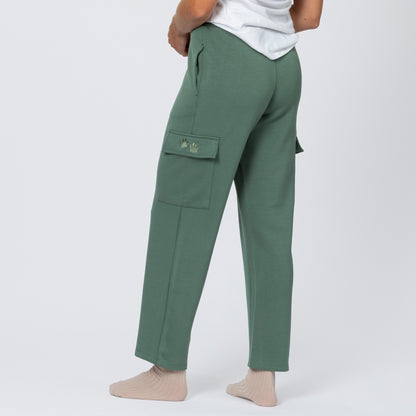 Green cargo pants worn by a person on a white background