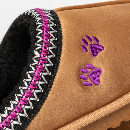 Close-up of a brown slipper with purple paw prints and a patterned trim.