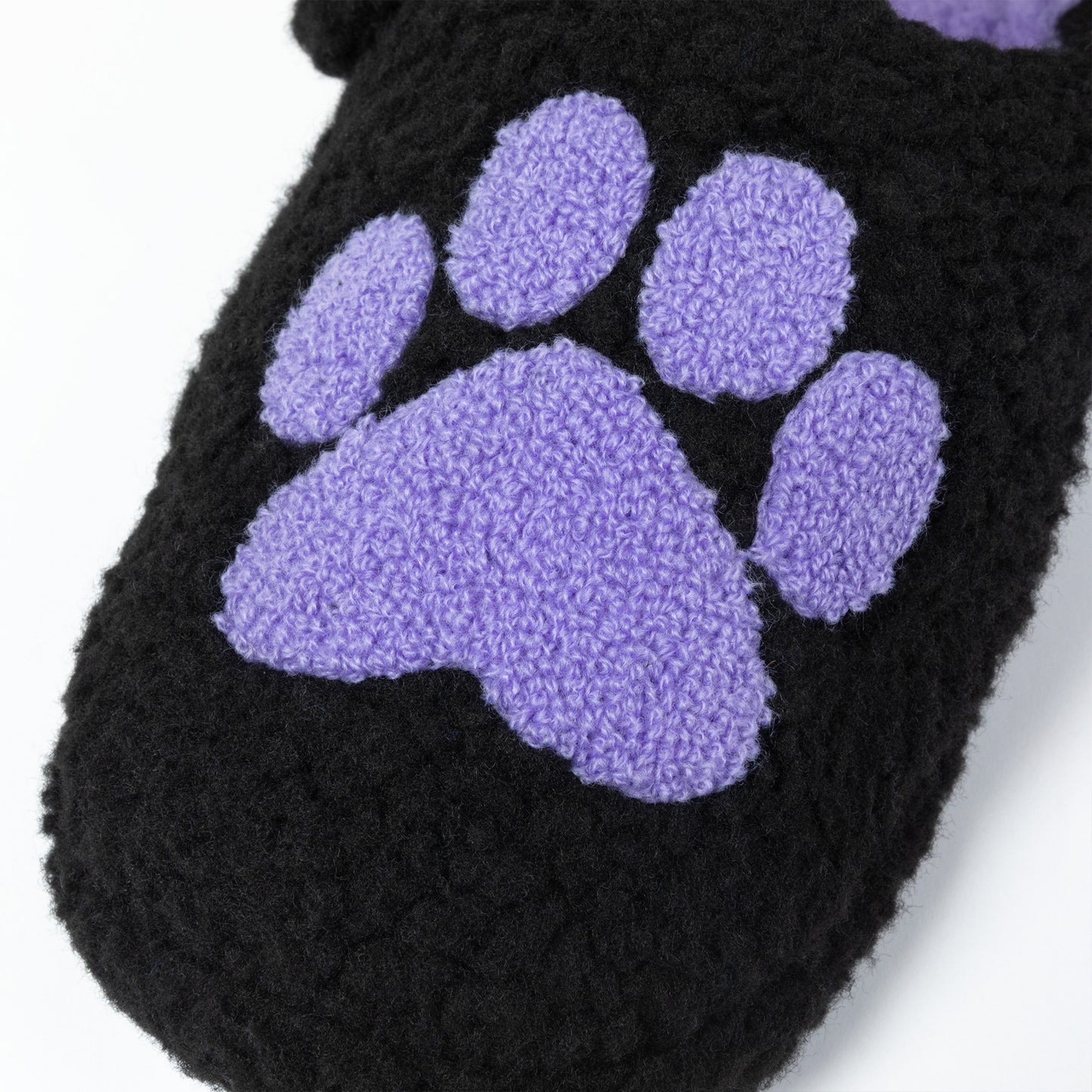 Black slipper with a purple paw print on a white background