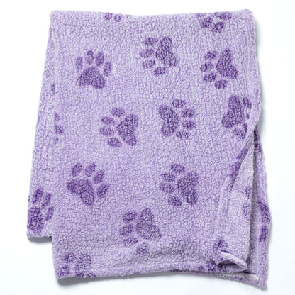 A lavender purple plush fleece blanket with a repeating dark purple paw print pattern, folded neatly on a white background.