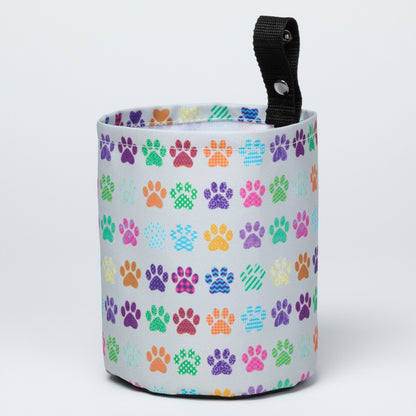 Collapsible car garbage holder with multicolor paw print pattern on a white background