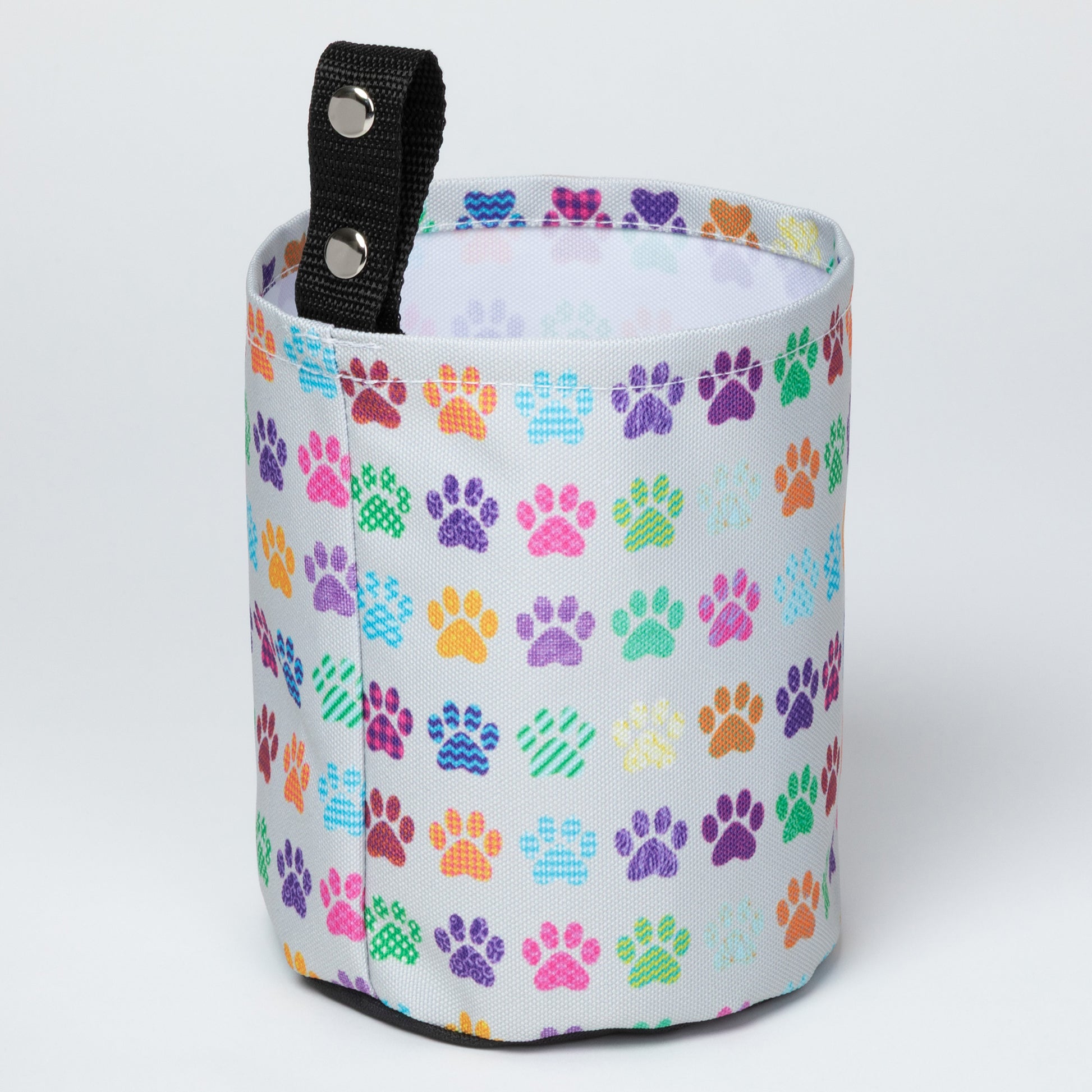 Collapsible car garbage holder with multicolor paw print pattern on a white background
