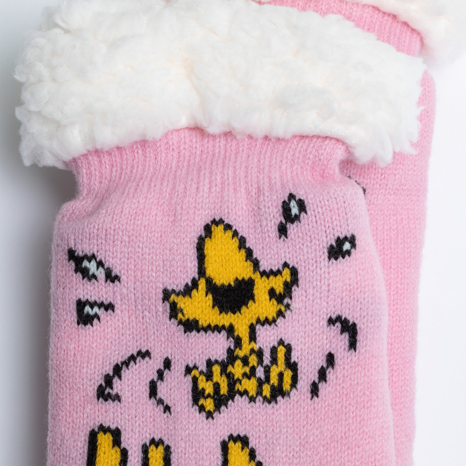 Pink knitted hat with a cartoon character design on a white background