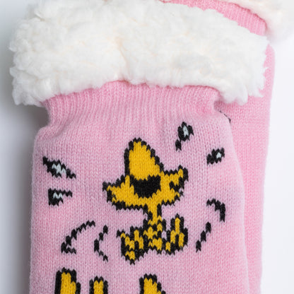 Pink knitted hat with a cartoon character design on a white background