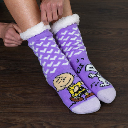 Purple socks with cartoon characters on a wooden floor