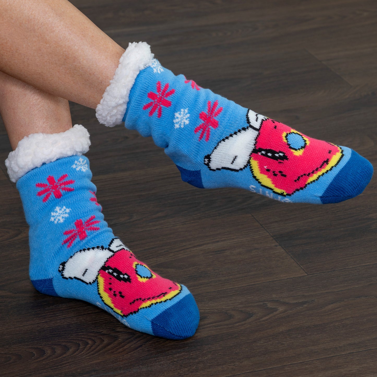 Colorful socks with cartoon design on a wooden floor