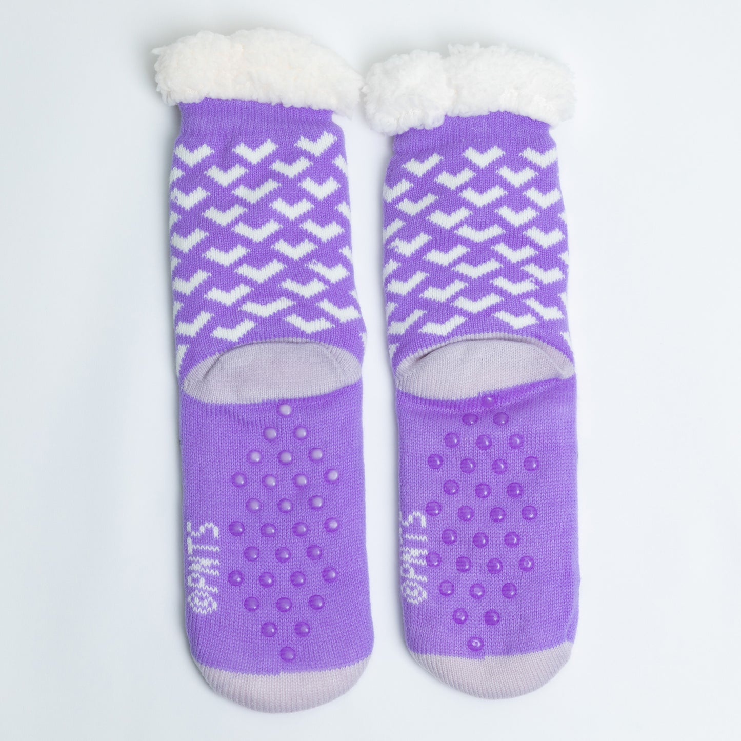 Pair of purple socks with white patterns and textured sole on a light gray background