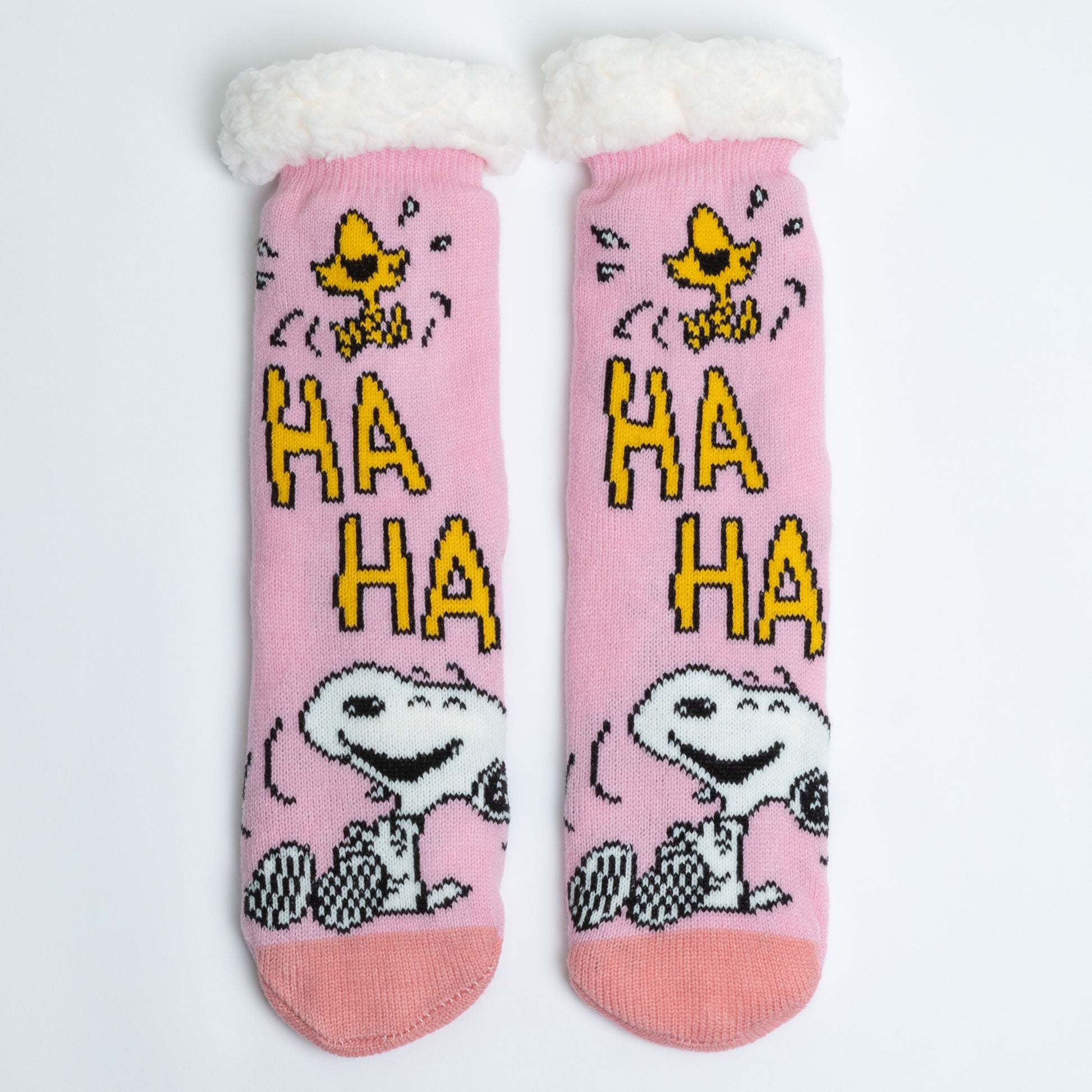 Pink socks with cartoon characters and 'HA HA' text on a white background