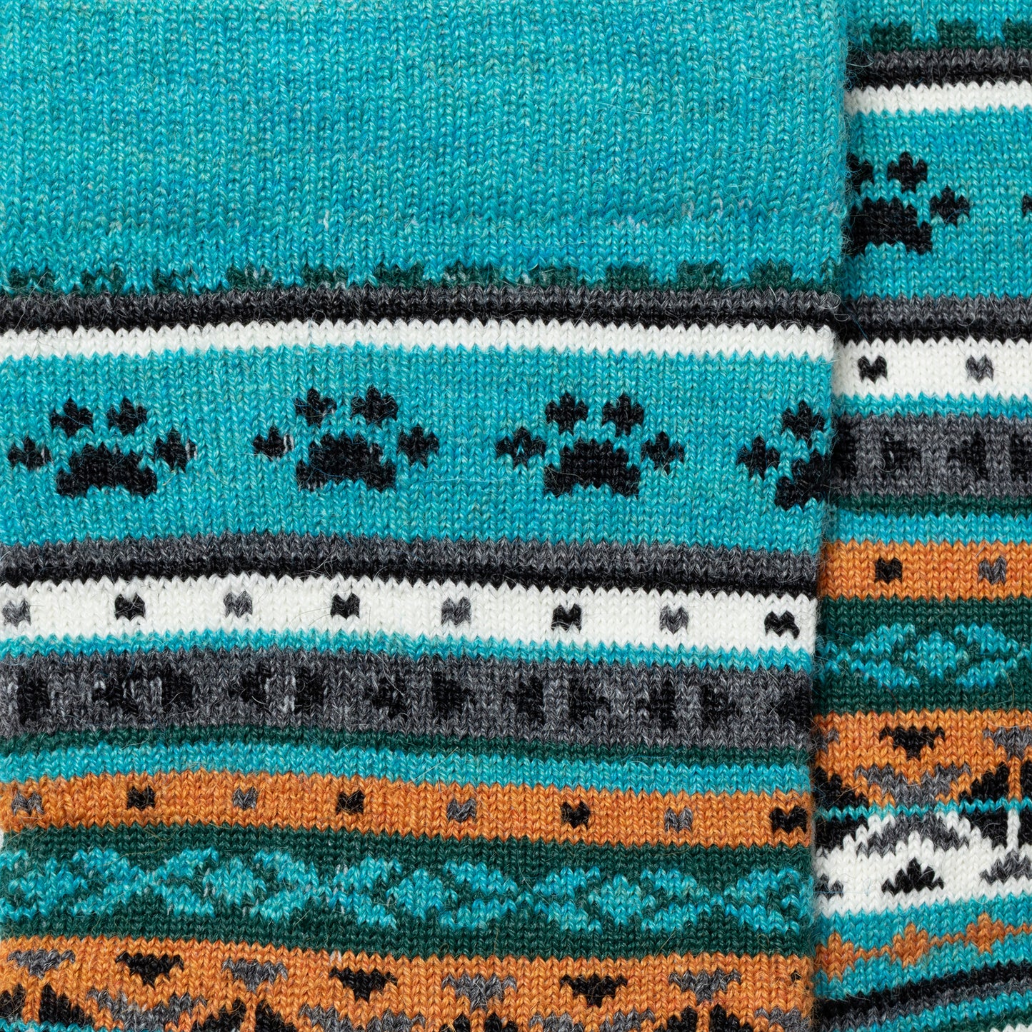 Close-up of a patterned fabric with blue, orange, and black colors.