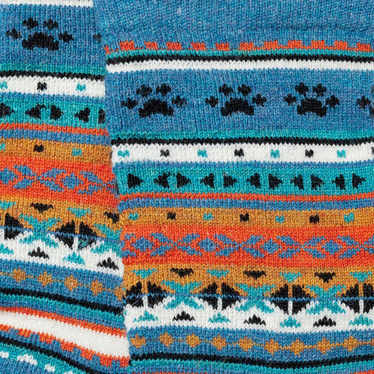 Close-up of colorful knitted fabric with geometric pattern and paw prints