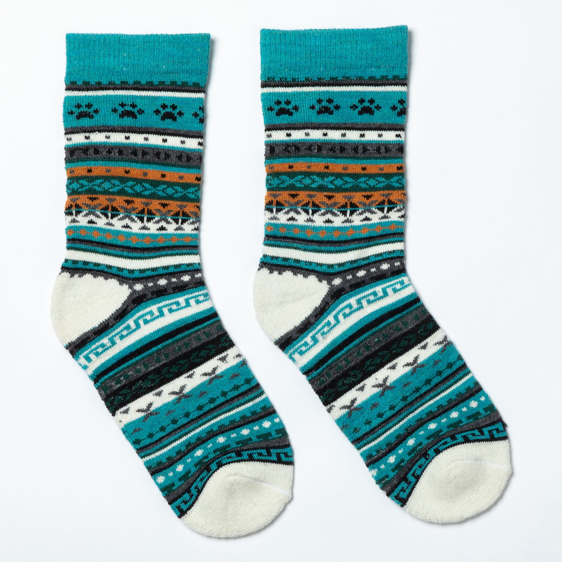 Pair of patterned socks with teal, black, and white design on a white background